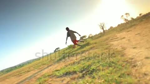 Children playing soccer on the fields in Kenya