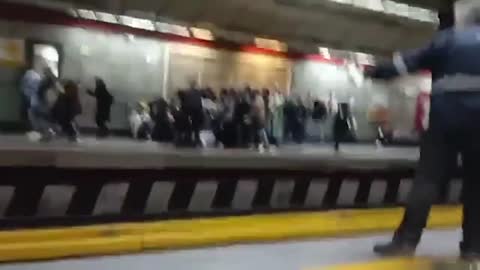 People run for cover as Iranian police appear to open fire on Tehran metro station platform