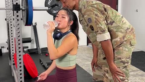 military husband reunites with wife in gym!