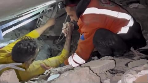 A Palestinian is rescued from the rubble in Gaza following an Israeli airstrike