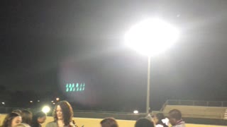 Ghostly wisps floats above gathering on football field