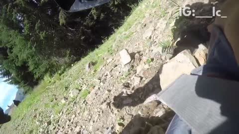 Guy mountain biking and falls down