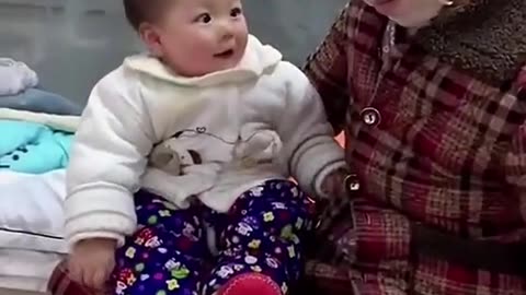 Baby surprised seeing her mother wearing face mask