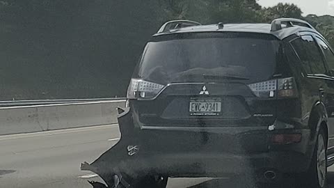 Car bumper hanging on the road