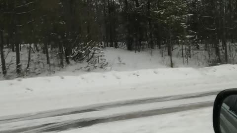 We drive a car through the city through a forest in a blizzard.