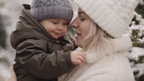 A Woman Kissing and Playing with her Baby