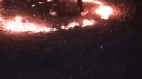 Guys fight in a circle of fire