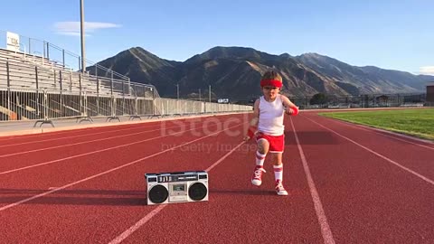 A young boy dressed in a headband and retro workout