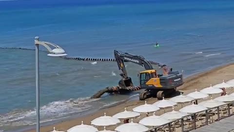 Dredging ship restores an eroded beach.