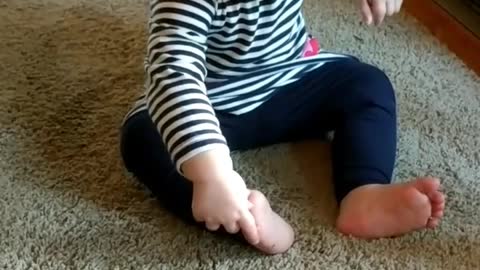 Flexible Baby Girl Eats Kix Cereal With Her Toes