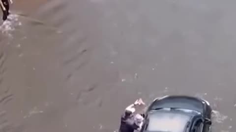 Florida driver rescued by officers from floodwaters after Storm Debby.