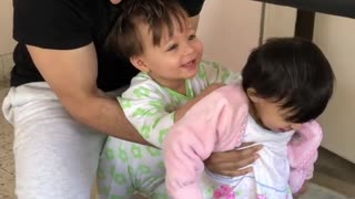 Dad helps babies walk the treadmill