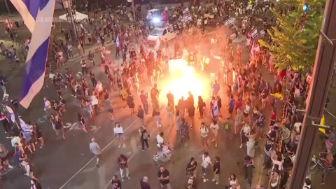 Demonstrators light bonfire during protest and scuffle with Israeli police