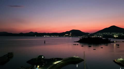 Intense Red Sunset Over the Sea with Mountain Backdrop in Yeosu