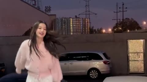 A beautiful Asian girl, dancing a lovely dance