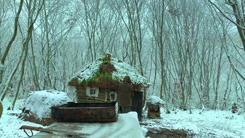 Building complete and warm survival shelter Bushcraft log cabin, grass roof & fireplace with clay.