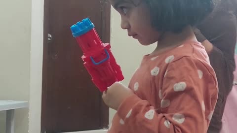 Kid playing with bubble gun