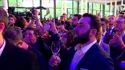 Cheers for Macron, Le Pen supporters boo results