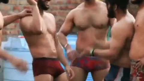 muscular mens enjoying raining day