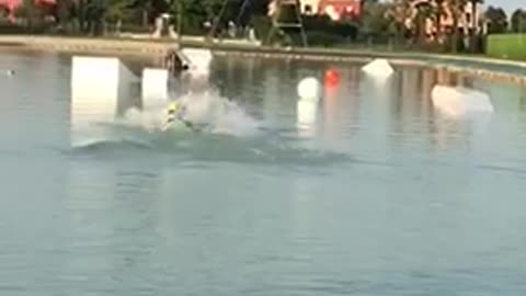 Wakeboarding guy yellow helmet faceplants