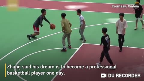 A young child plays basketball with one hand better than any other player