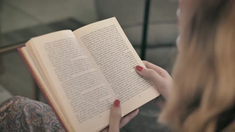 Blonde woman reading a book