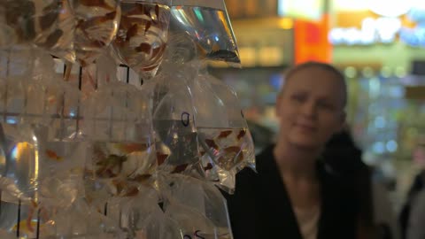 woman viewing fish for sale