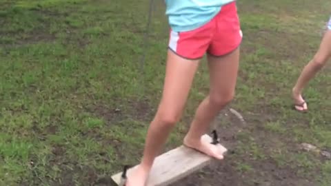 Girl stands on swing spins and falls