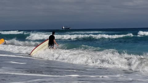 Surfers enjoy a beautiful day - Atlantic Ocean, Palm Beach, Florida