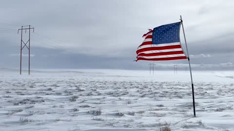 American Flag Blowing in Freezing Landscape