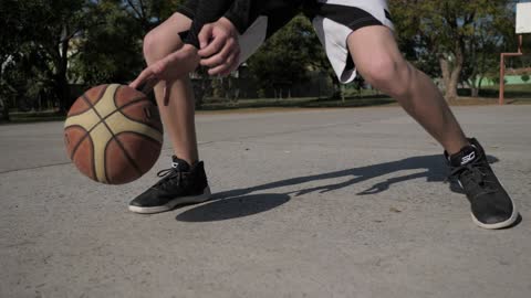 Basketball player dribbling ball