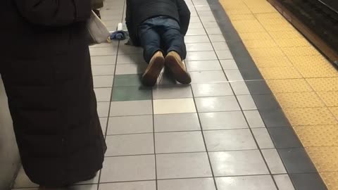 Man doing push ups next to train tracks