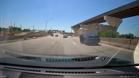 Driver Seen With Foot Hanging Out Open Door on Highway