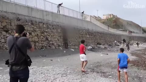 Migrant boy swims to beach in Spain's Ceuta with plastic bottles to stay afloat