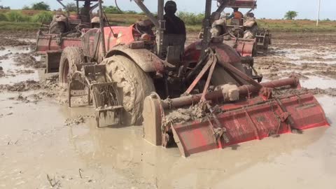 A tractor stuck in mud .