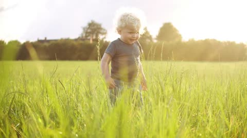 Young boy eating grass