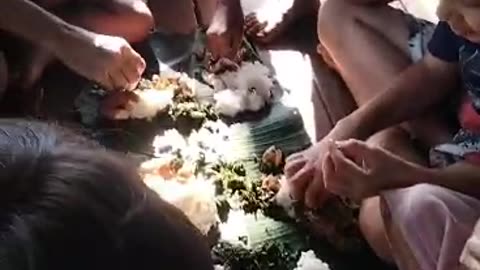 Fish, cassava leaves and rice on a banana leaf