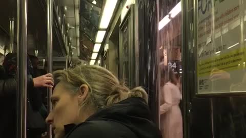 People stare at open subway door water pouring in