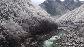 Suspension bridge in the mountains with snow