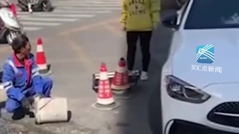 Woman in Mercedes argues with workers under construction