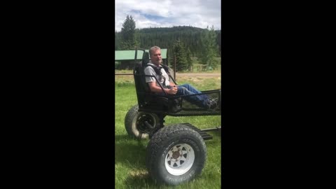 Man Sits on Spinning Chair Attached To a Small Tractor.