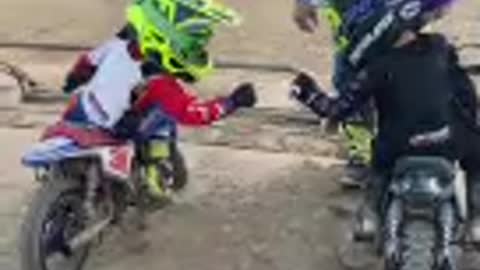 Two Kids Fail to Coordinate Their Fist Bump Before Racing on Mini Dirt Bikes