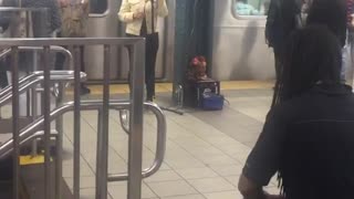 Woman sings man plays drums subway