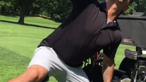 Guy black shirt on golf cart drinking beer