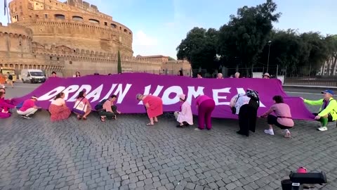 Activists unroll 'Ordain women' tapestry before Vatican synod