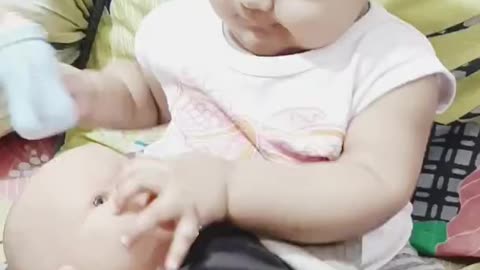 Cute baby playing with doll