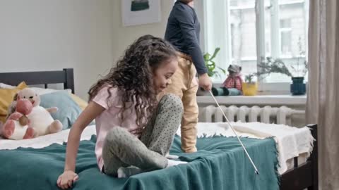 Children play bait catch with their cat in bedroom#short video