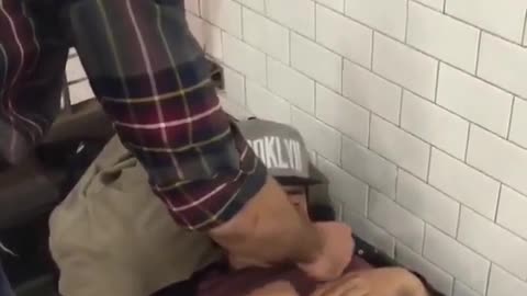 Guy lights up a homeless mans cigarette while he is sleeping