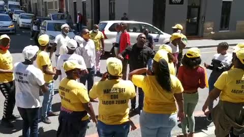 People dressed in ANC t shirts picket outside the High Court in Cape Town