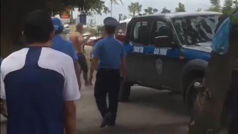 young man carrying a sword, wooden sword threatens traffic